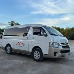 White passenger van parked outdoors with clear sky.