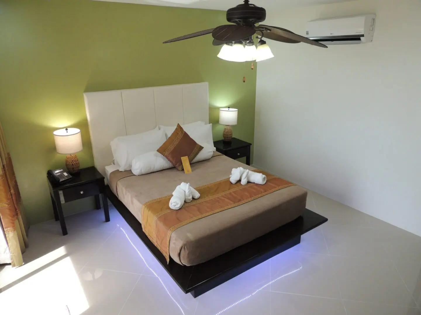 Cozy bedroom with a neatly made bed and soft lighting.