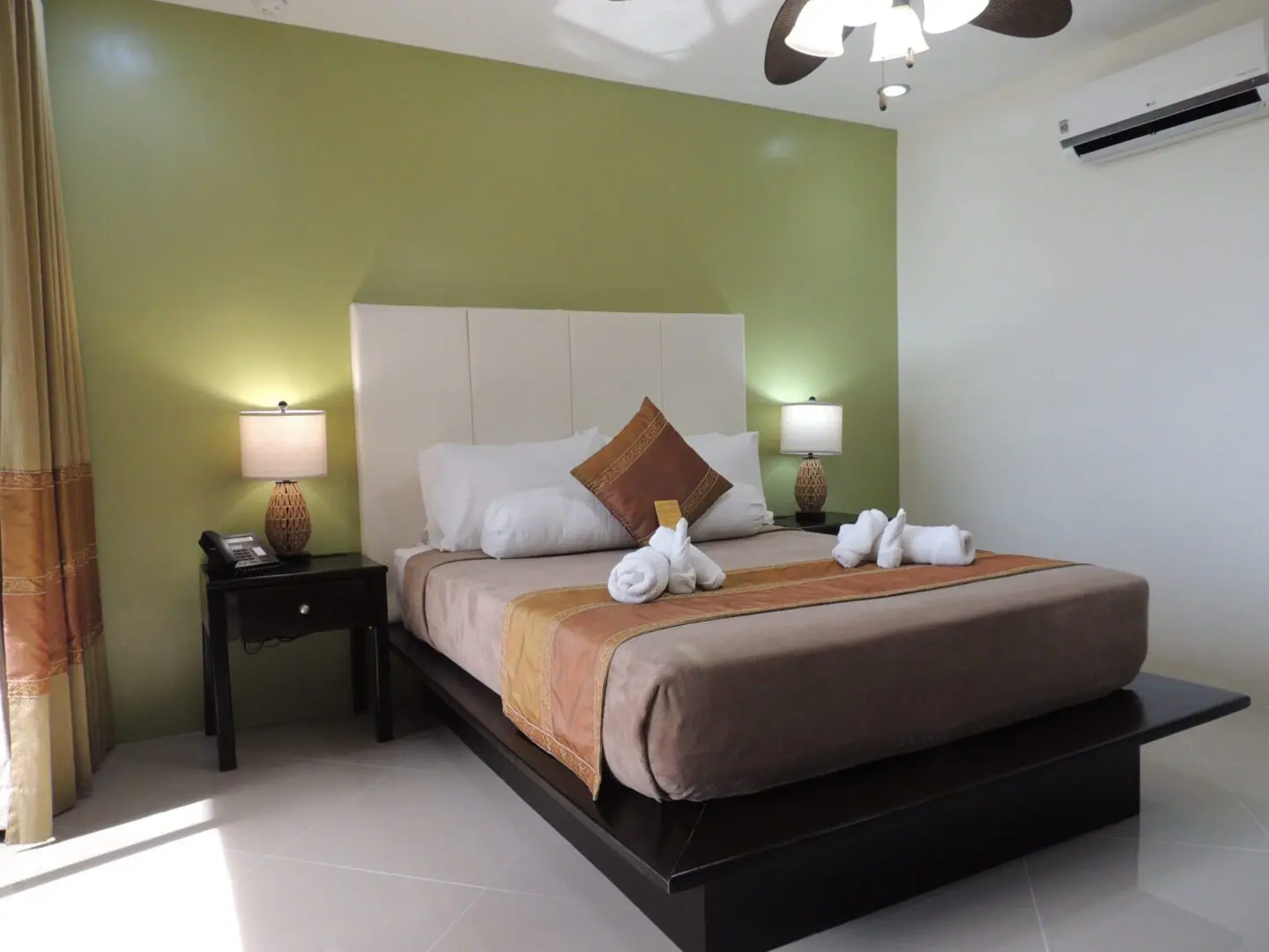 Cozy bedroom with a neatly made bed and warm lighting.