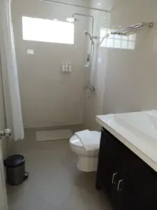 Clean bathroom with white walls, toilet, and vanity.