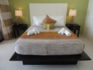Cozy hotel room with neatly arranged bed and towels.