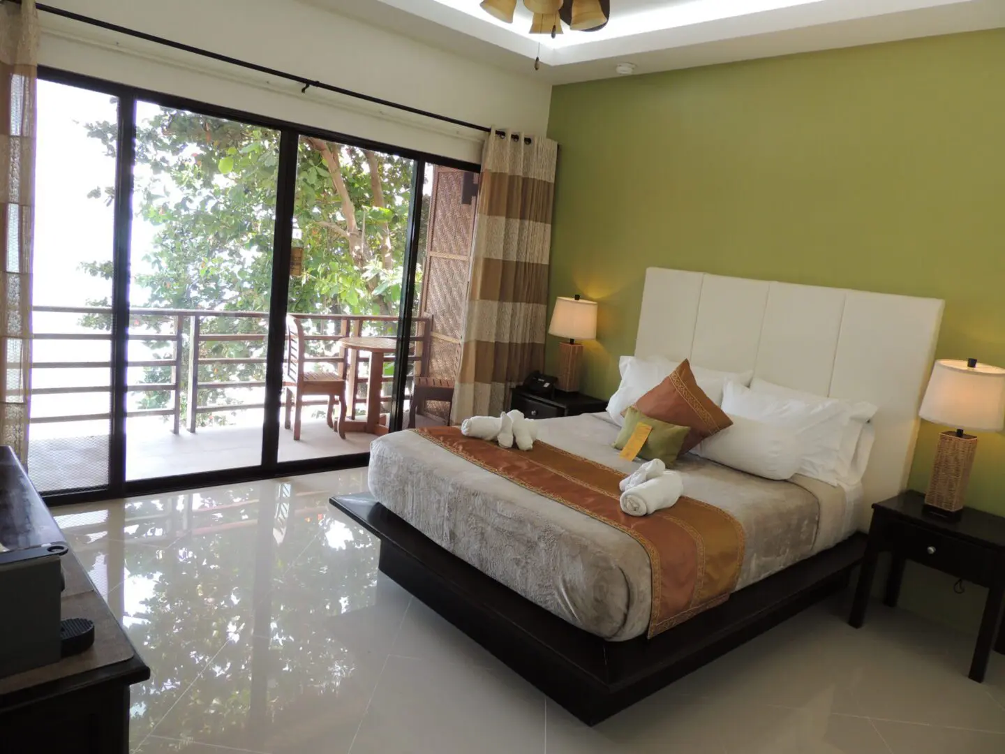 Cozy bedroom with a large bed and balcony access.