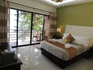 Cozy bedroom with large sliding glass doors and balcony view.