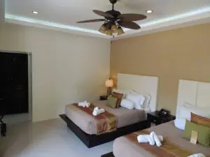 Cozy hotel room with a large bed and folded towels.