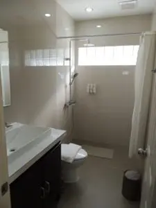 Bright, modern bathroom with white fixtures and tiled walls.